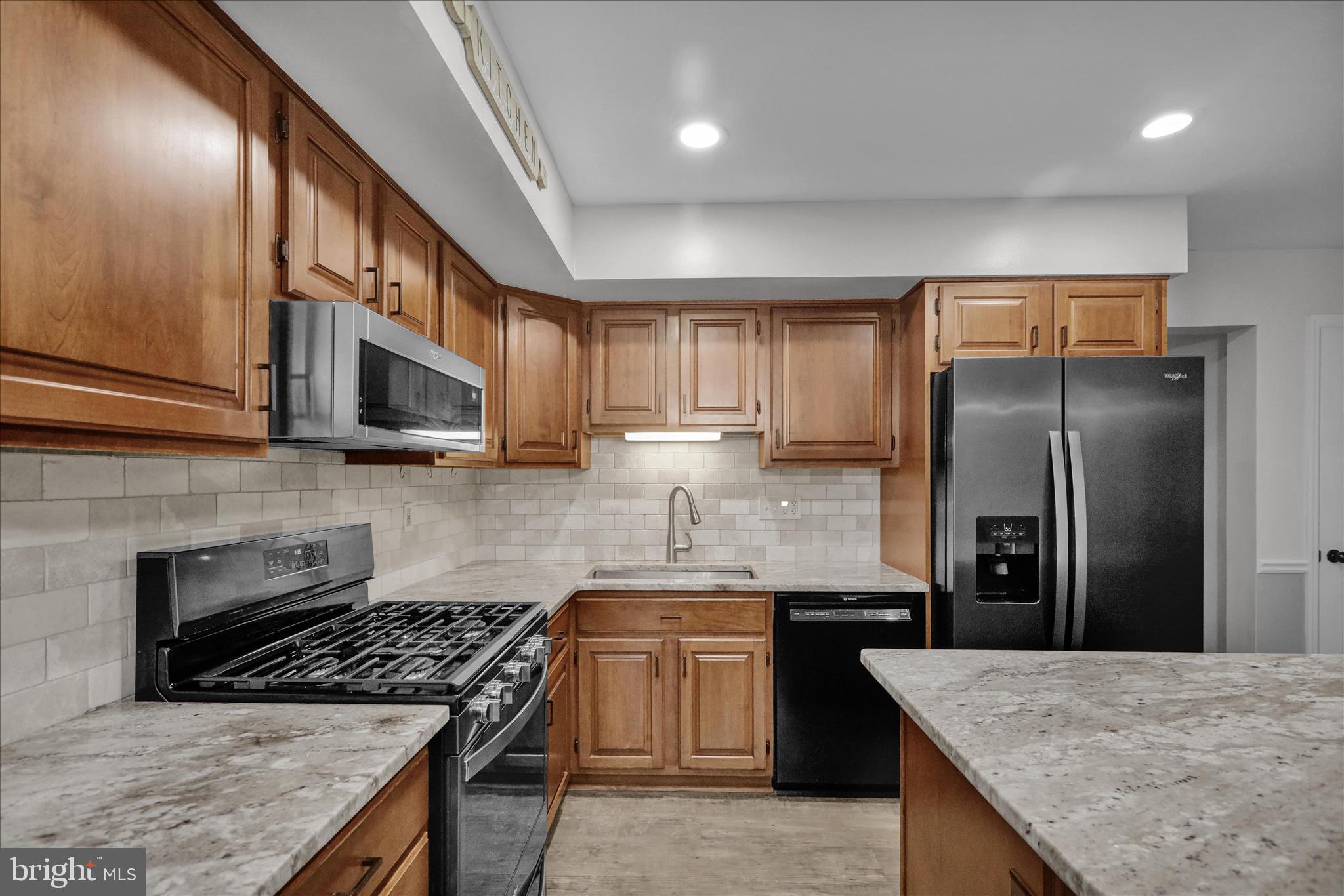 2930 Reedy Road Sinking Spring, PA 19608 - Photo 7 of 45 a kitchen with stainless steel appliances granite countertop a stove a refrigerator a sink and dishwasher
