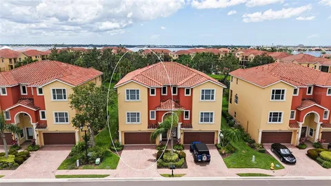 an aerial view of multiple houses with a yard