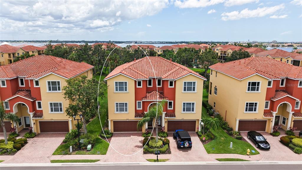 an aerial view of multiple houses with a yard