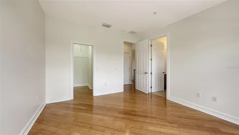 an aerial view of a house a yard and a pond