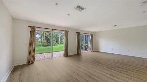 a living room with lots of furniture and wooden floors