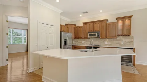 a kitchen with stainless steel appliances granite countertop a sink a stove and a refrigerator