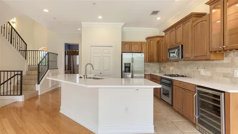 a kitchen with stainless steel appliances granite countertop a sink a stove a microwave a counter space and cabinets