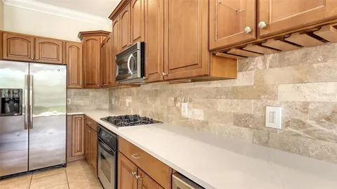 a view of an empty room with glass door and balcony