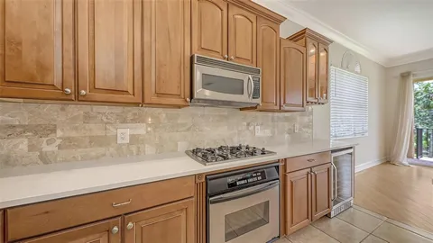 a view of empty room with wooden floor and fireplace