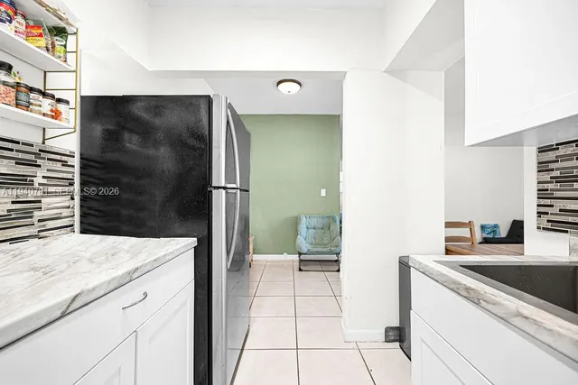 a bathroom with a granite countertop sink a toilet and a shower