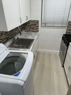 a kitchen with a sink and washing machine