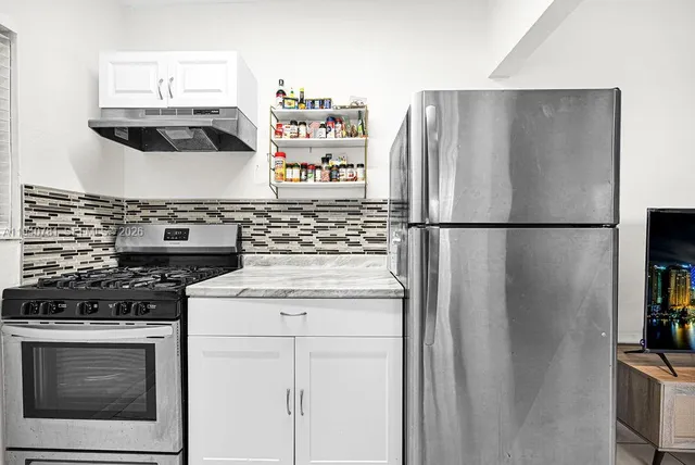 a kitchen with appliances and cabinets
