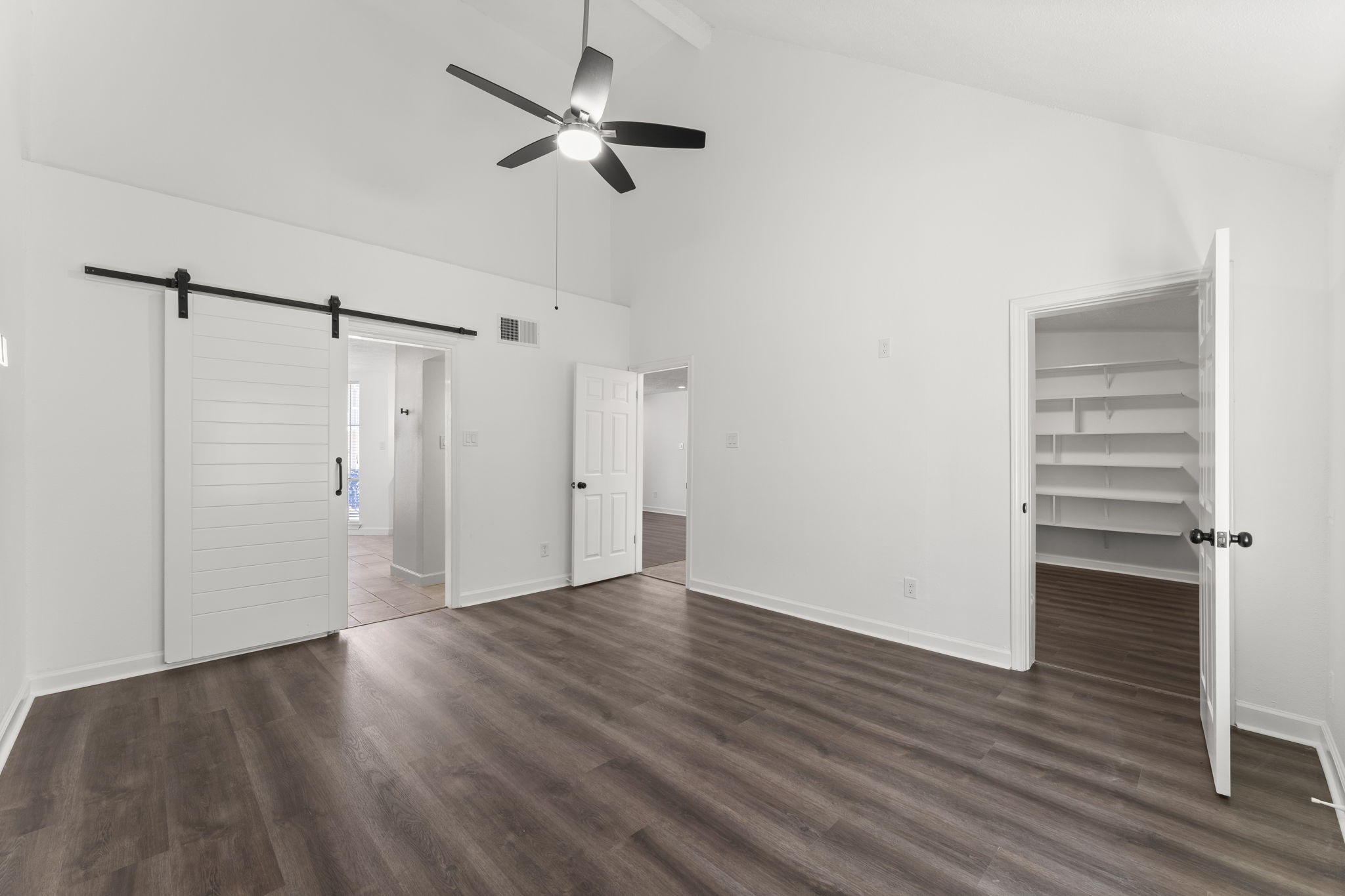 1678 Beaconshire Houston, TX 77077 - Photo 11 of 30 a view of empty room with wooden floor and ceiling fan