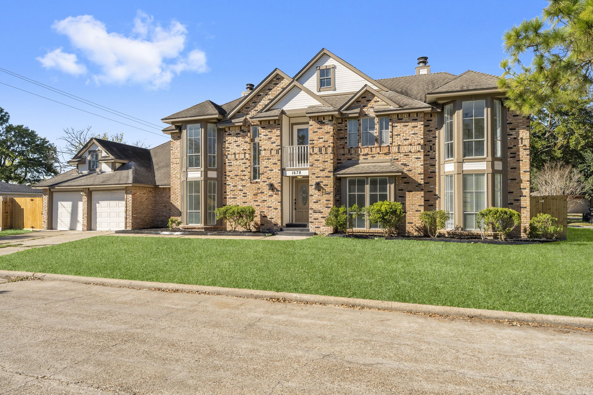 1678 Beaconshire Houston, TX 77077 - Photo 2 of 30 a front view of a house with a garden and yard