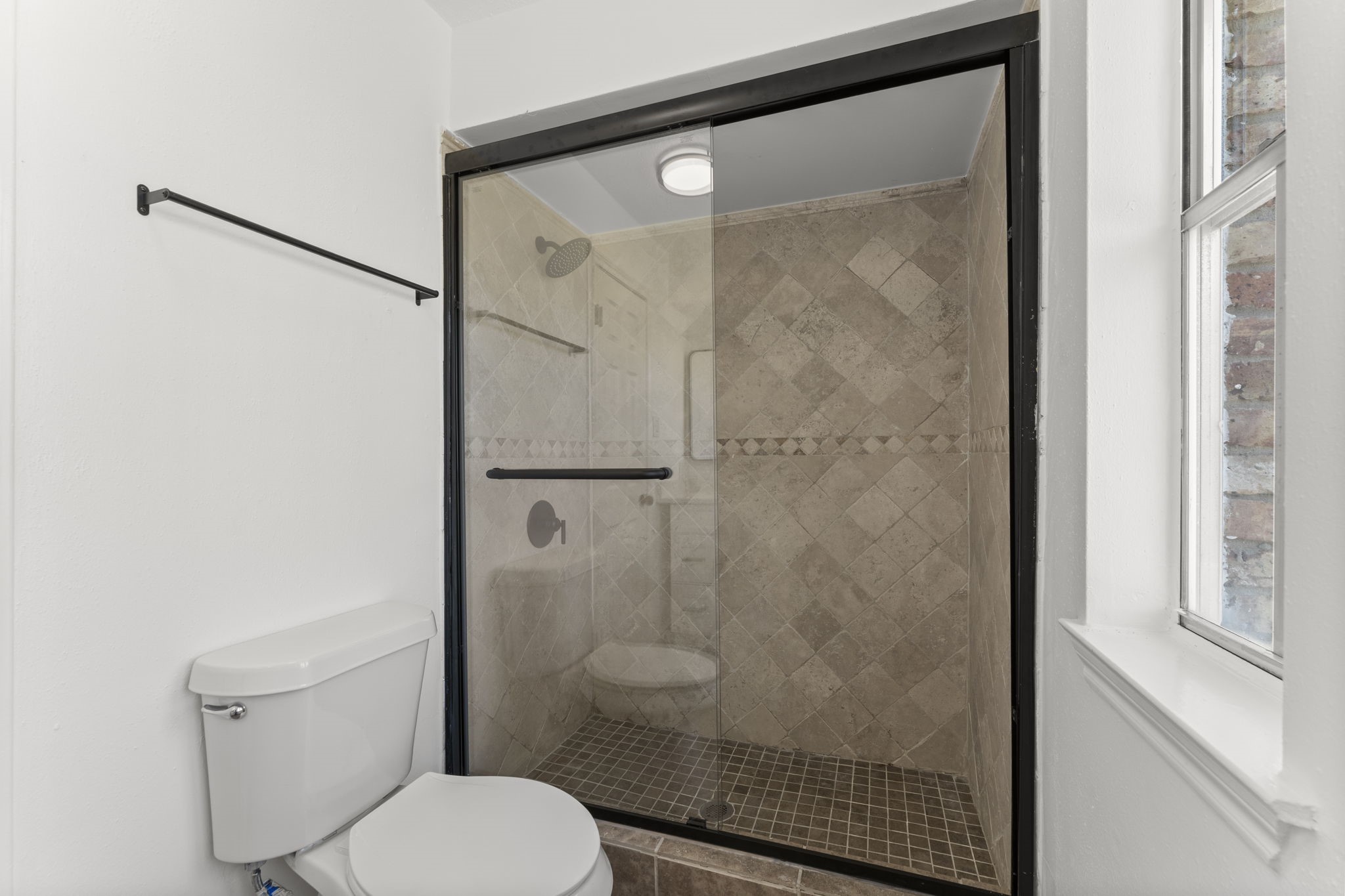 1678 Beaconshire Houston, TX 77077 - Photo 23 of 30 a bathroom with a toilet and a shower