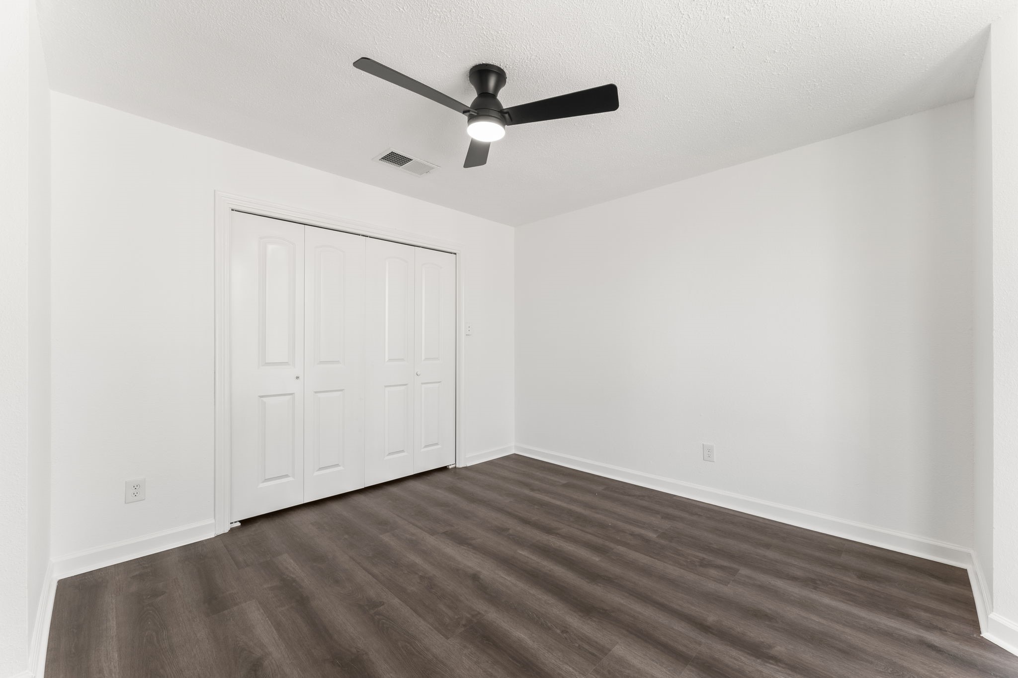 1678 Beaconshire Houston, TX 77077 - Photo 25 of 30 an empty room with wooden floor and a ceiling fan
