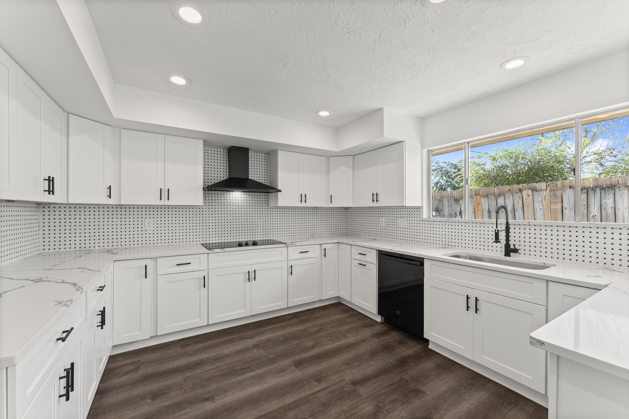 1678 Beaconshire Houston, TX 77077 - Photo 8 of 30 a kitchen with granite countertop white cabinets white appliances a sink and a large window
