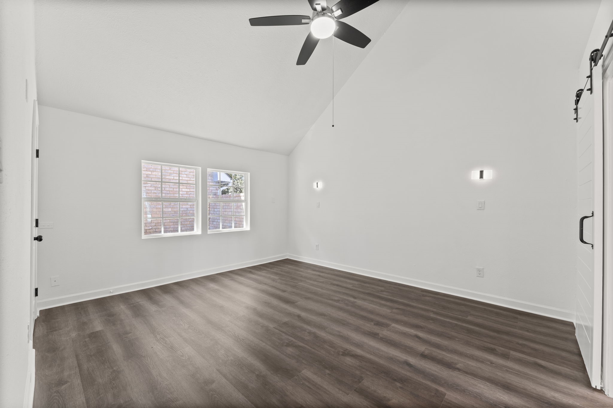 1678 Beaconshire Houston, TX 77077 - Photo 10 of 30 an empty room with wooden floor fan and windows