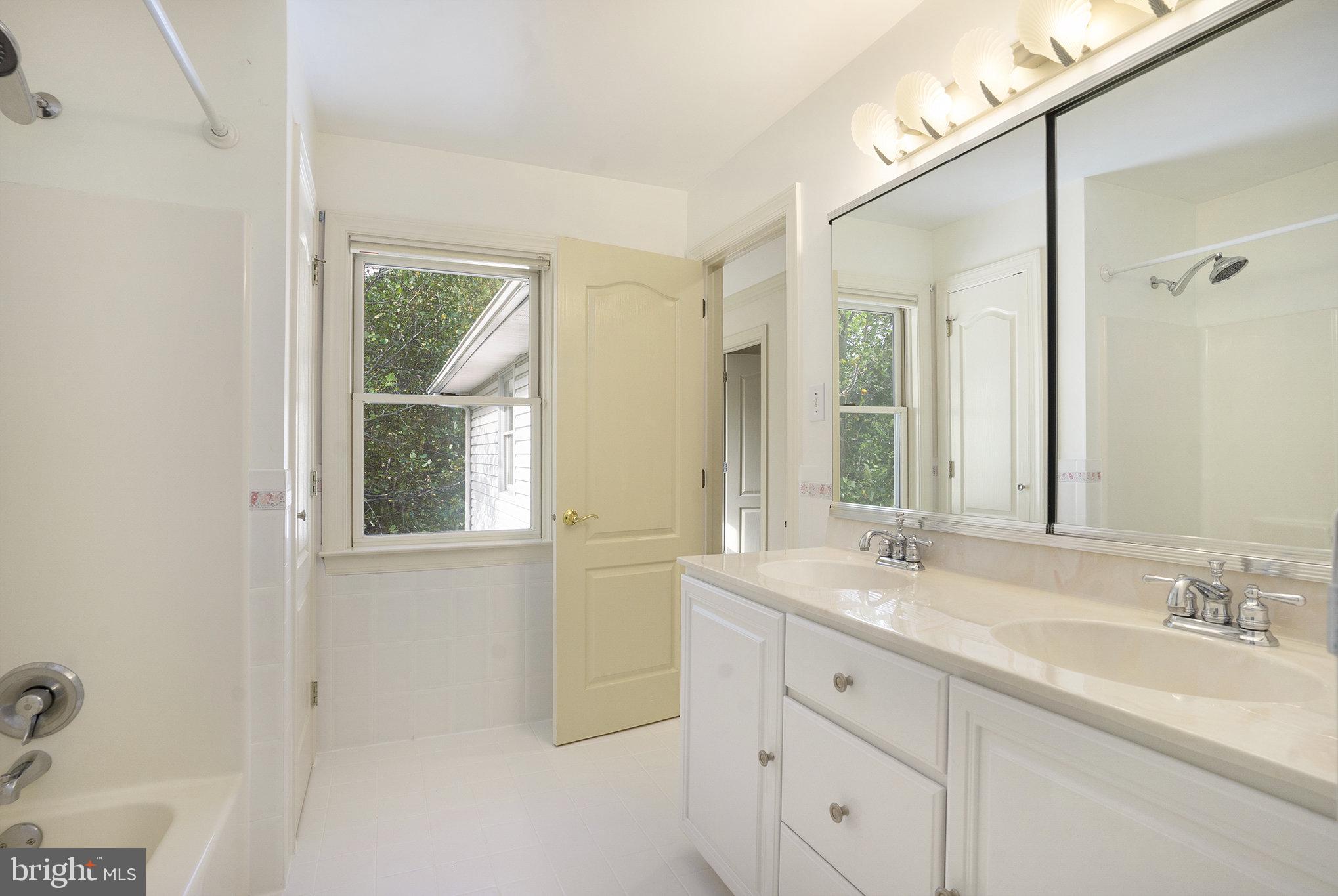 0 Tower Road Sellersville, PA 18960 - Photo 51 of 70 a bathroom with double vanity sink a mirror and a bathtub