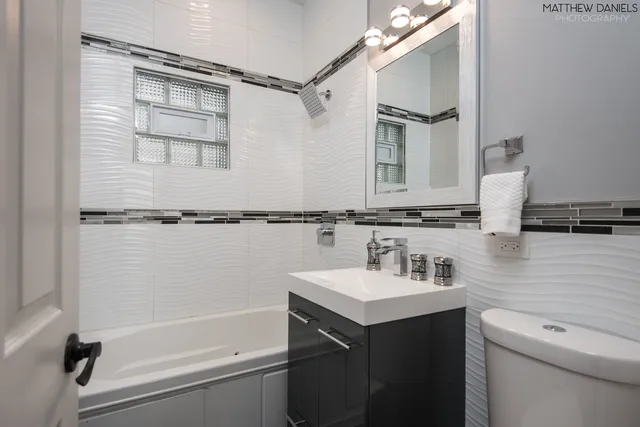 a bathroom with a sink a toilet and a tub