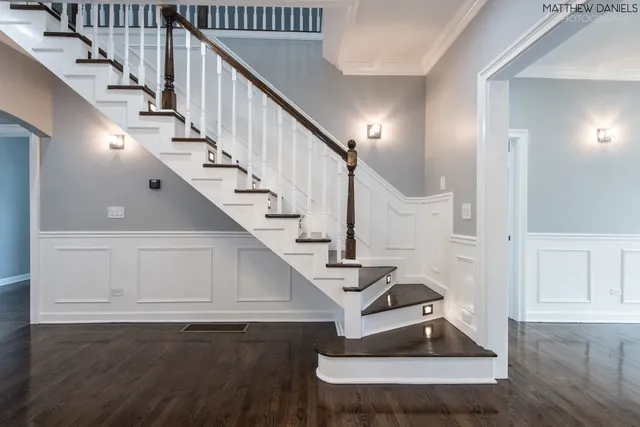 a view of entryway and hall with wooden floor