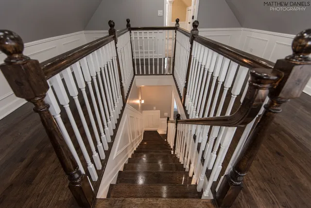 a view of stairs and hall with wooden floor
