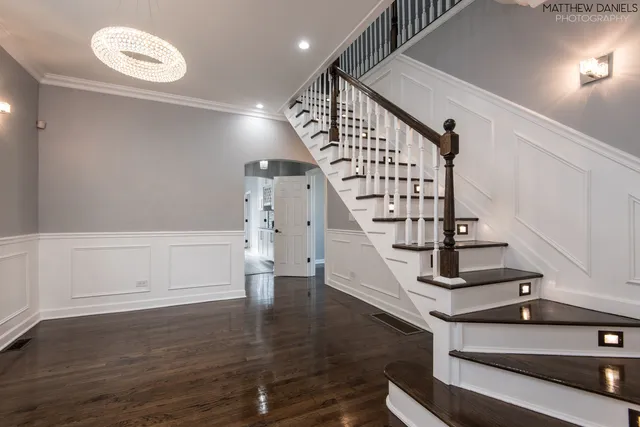 a view of entryway and hall with wooden floor