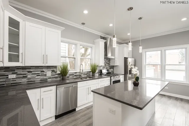 a kitchen with sink stove and cabinets