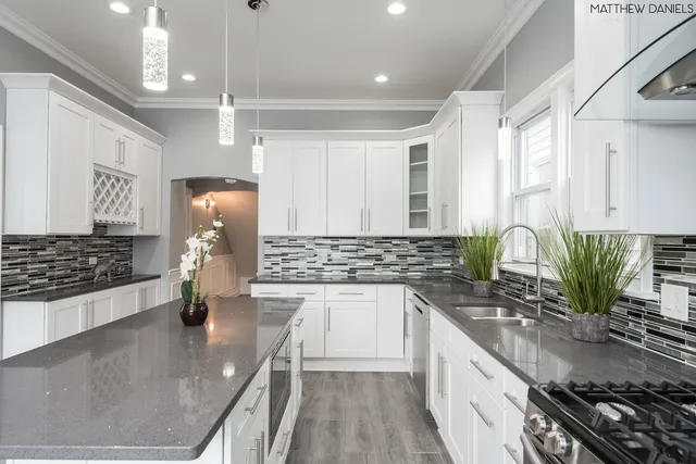 a kitchen with sink a stove and cabinets