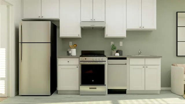 a kitchen with stainless steel appliances granite countertop a refrigerator and a stove