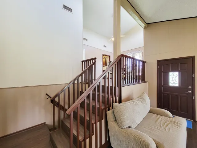 a living room with furniture or stairs and a wooden floor