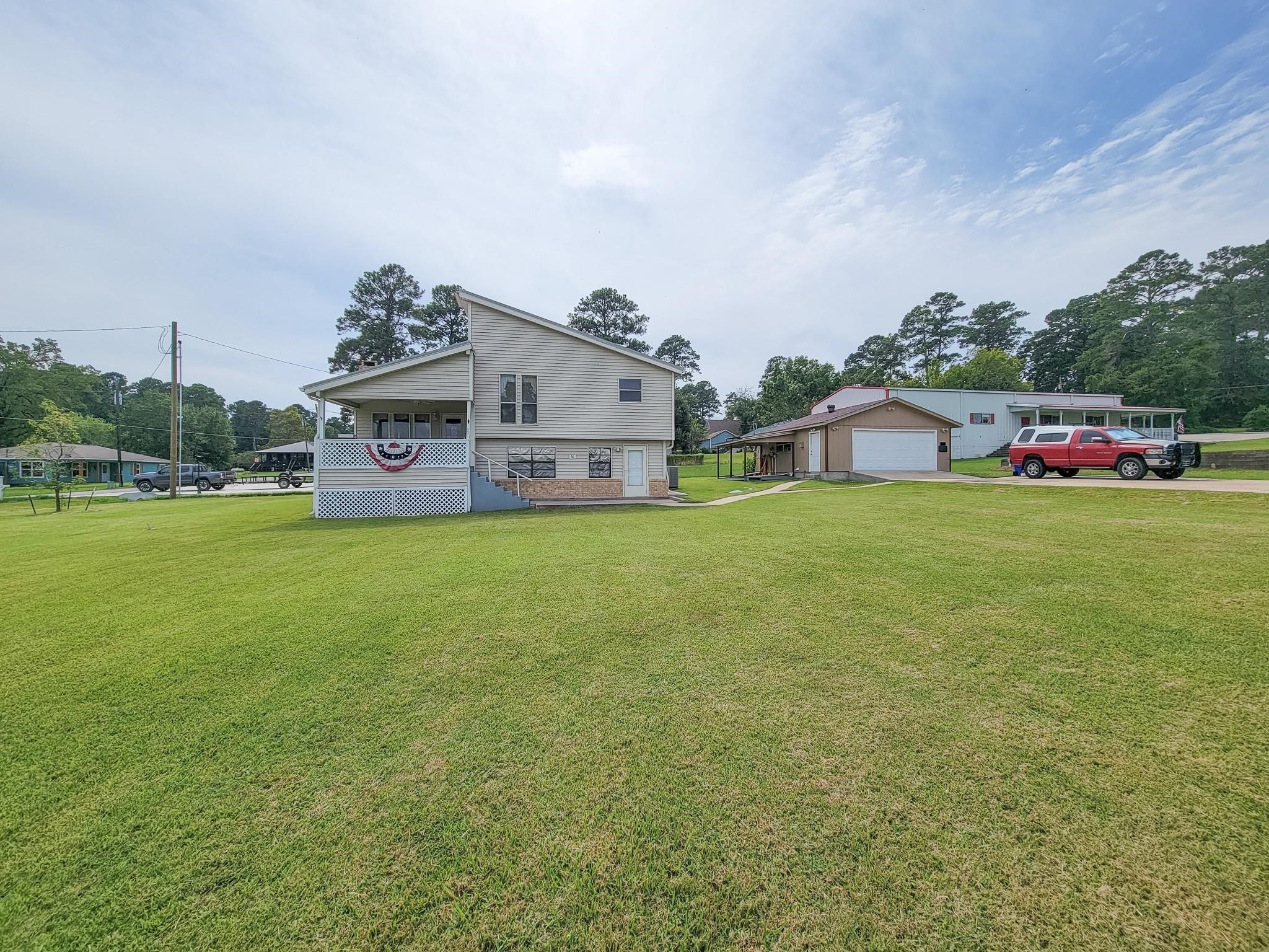 50 Sportsman Trail Coldspring, TX 77331 - Photo 2 of 42 a view of a house with a yard and garage
