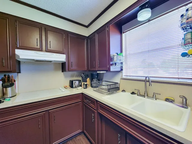a kitchen with a sink and cabinets
