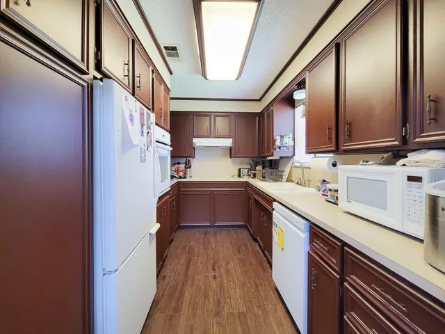 a kitchen with granite countertop a sink stainless steel appliances and cabinets