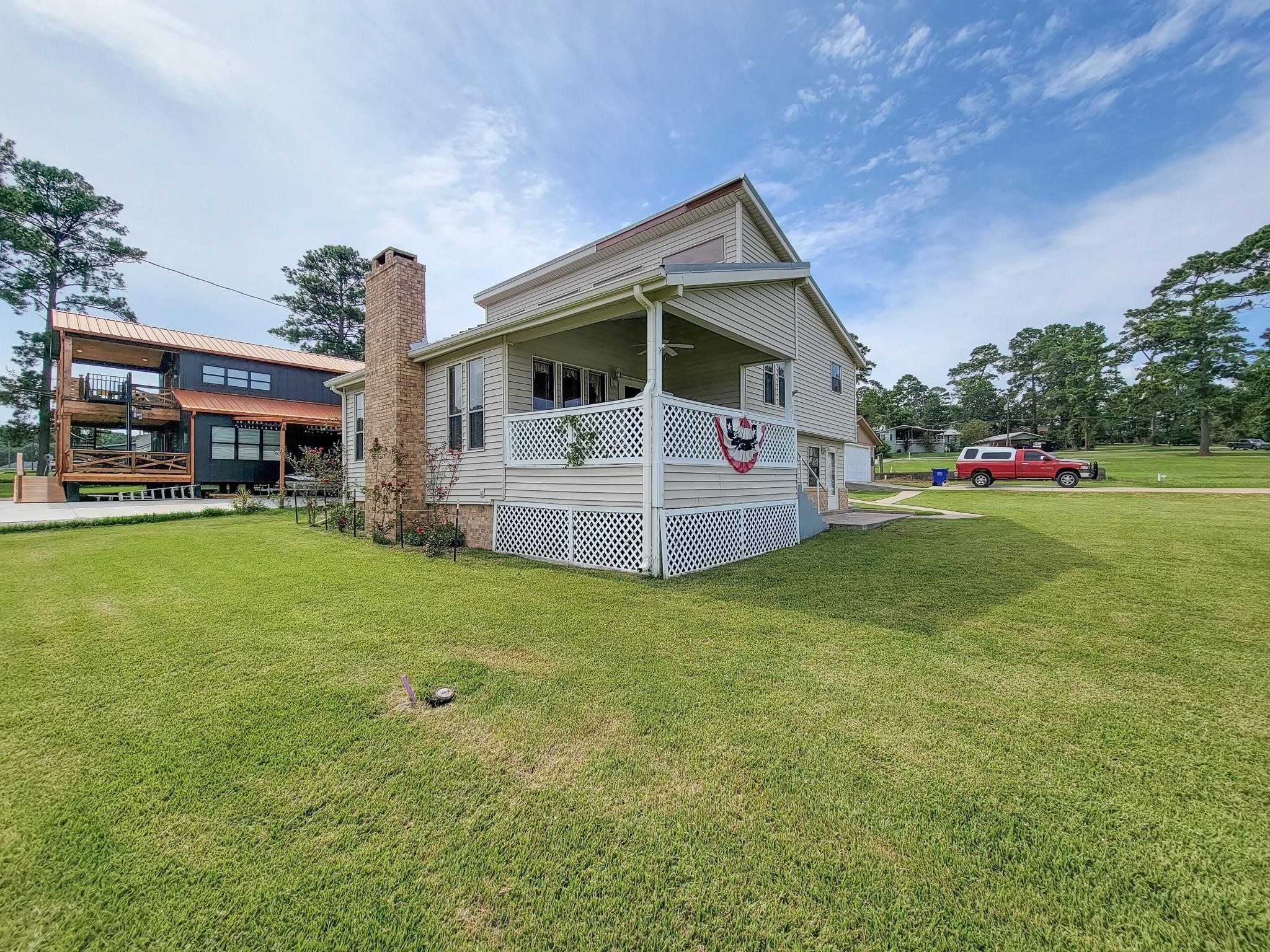 50 Sportsman Trail Coldspring, TX 77331 - Photo 3 of 42 a front view of a house with a yard table and chairs