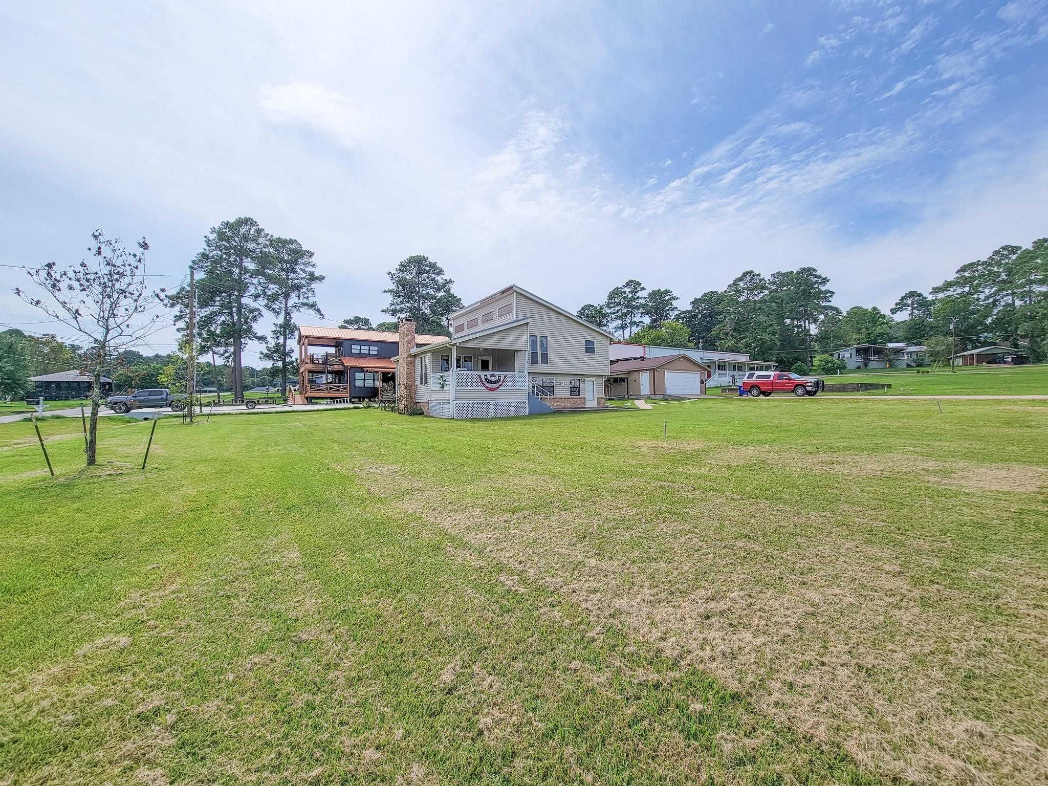 50 Sportsman Trail Coldspring, TX 77331 - Photo 32 of 42 a view of a house with a big yard and large trees