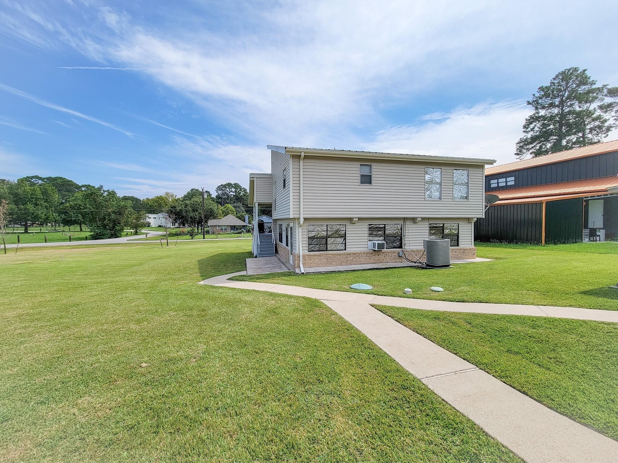 50 Sportsman Trail Coldspring, TX 77331 - Photo 40 of 42 a view of a house with a big yard potted plants and large tree