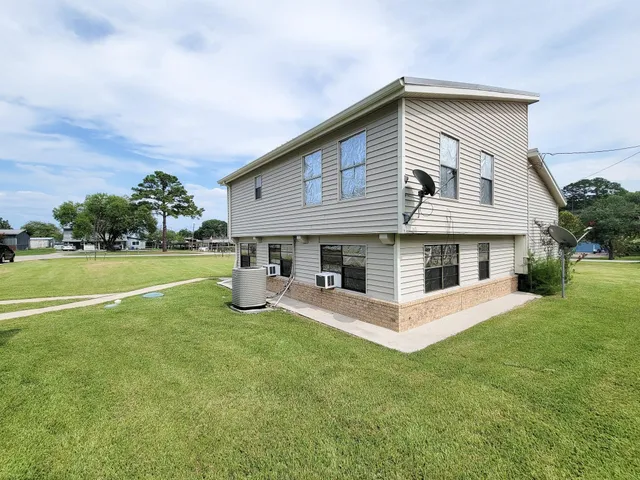 a front view of a house with a yard and a garage