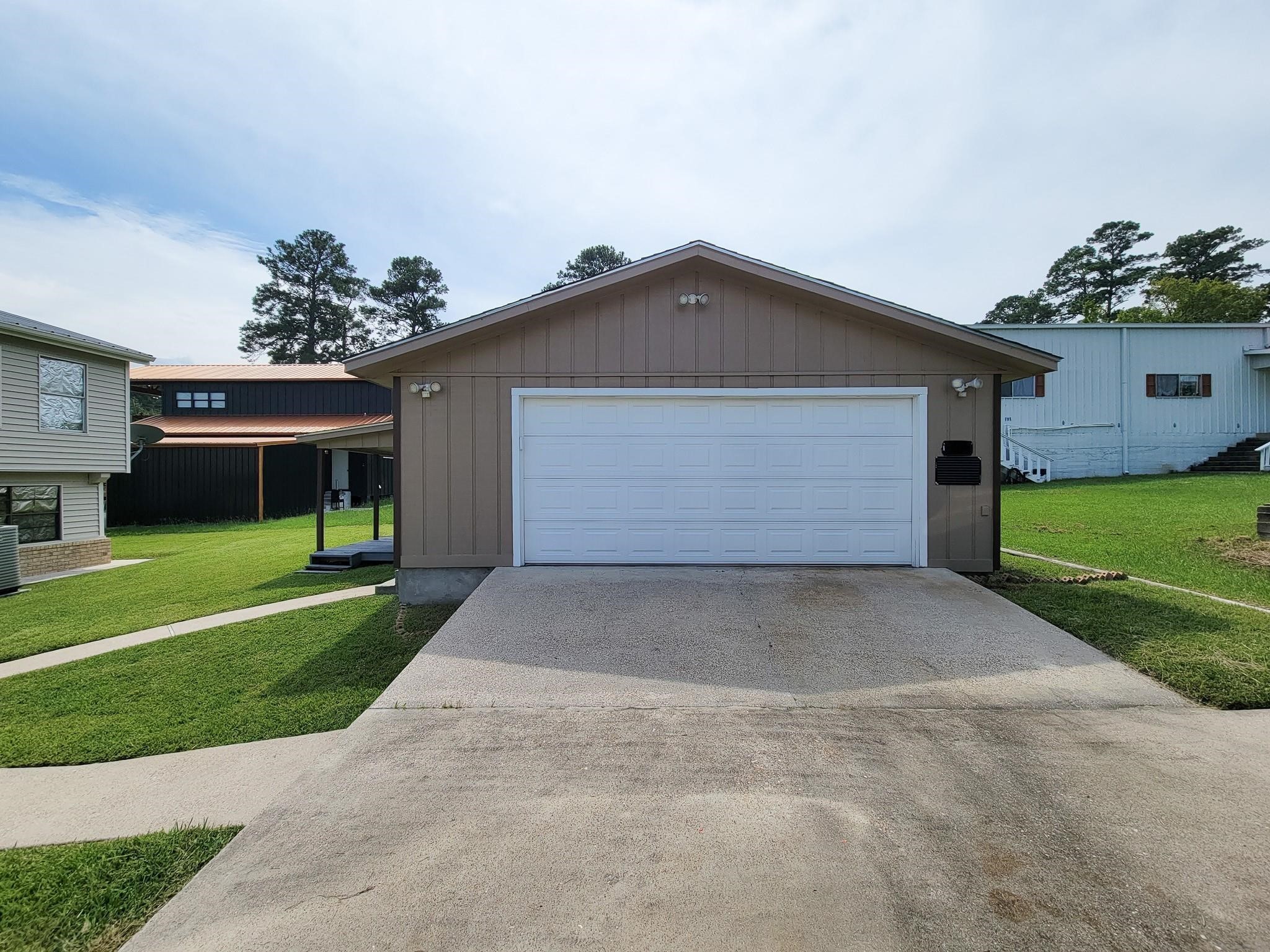 50 Sportsman Trail Coldspring, TX 77331 - Photo 42 of 42 a front view of a house with a yard and a garage