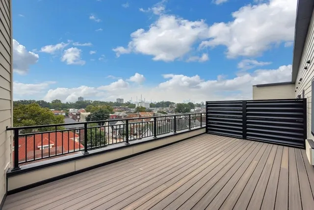 a view of a balcony with wooden floor