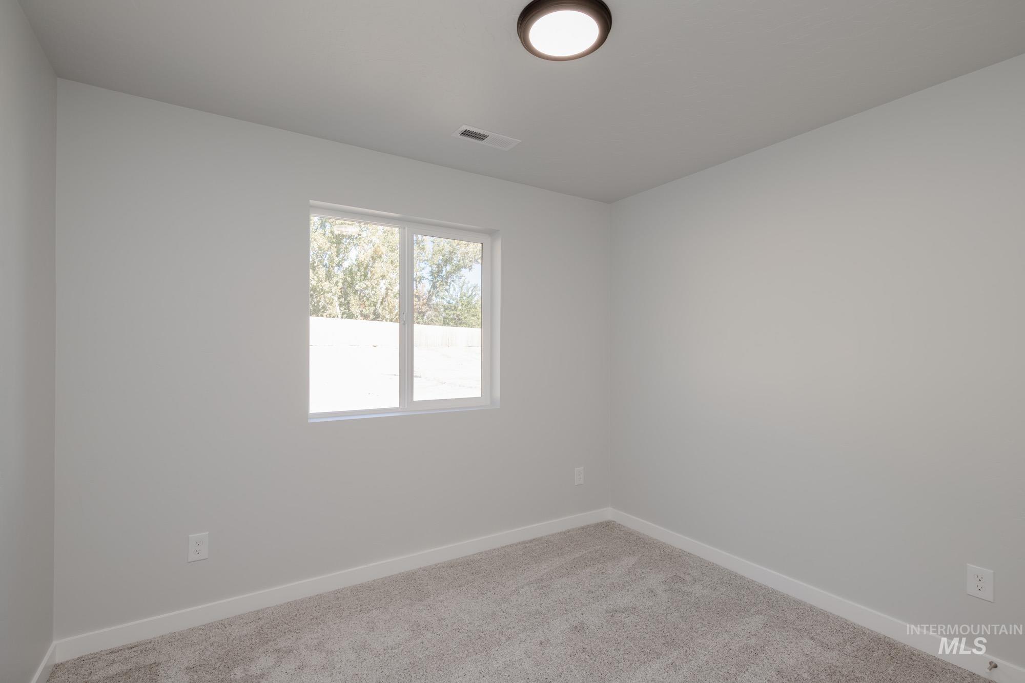 3230 South Maple Rnch Way Nampa, ID 83686 - Photo 15 of 27 Spare room featuring carpet and baseboards