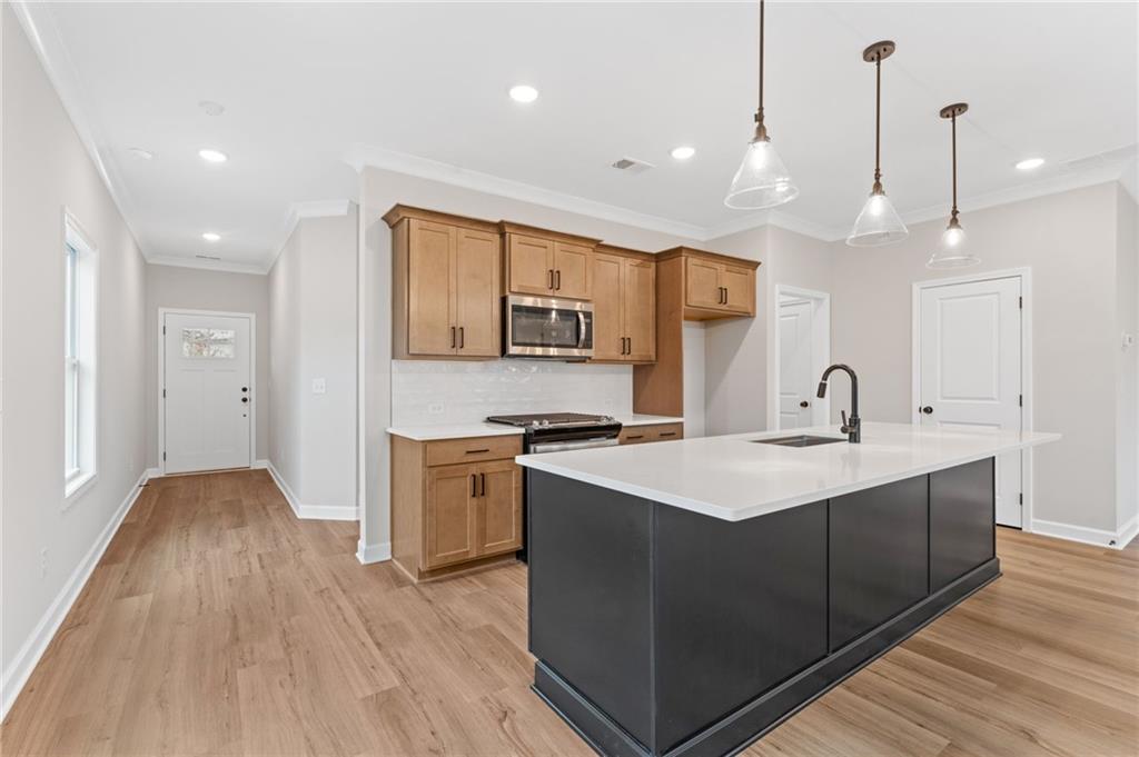 328 Colsen Drive Acworth, GA 30102 - Photo 12 of 28 a kitchen with stainless steel appliances granite countertop a sink a stove and a wooden floors