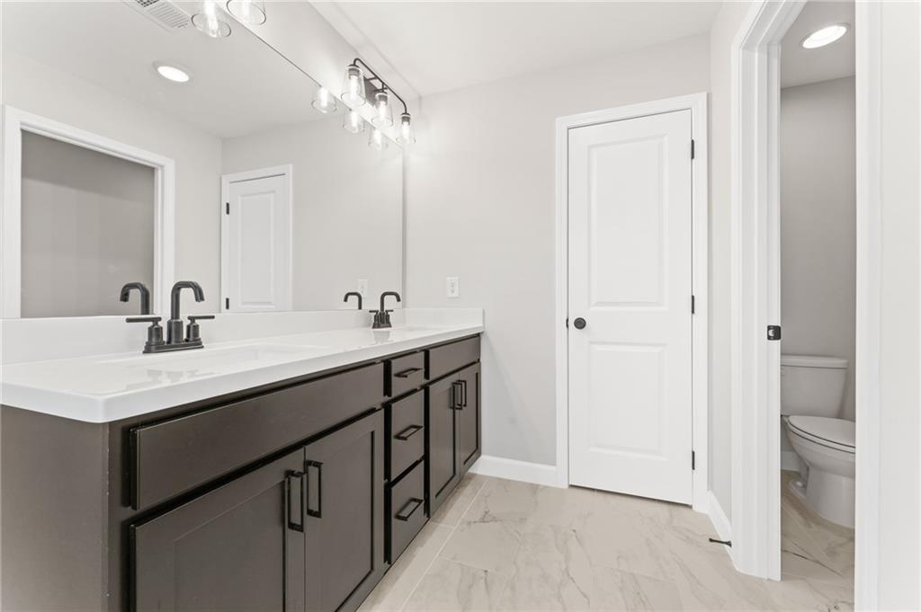 328 Colsen Drive Acworth, GA 30102 - Photo 21 of 28 a bathroom with a double vanity sink a mirror and a shower