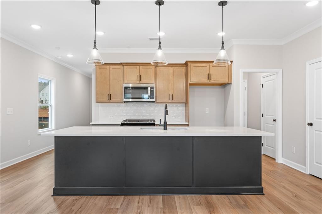 328 Colsen Drive Acworth, GA 30102 - Photo 3 of 28 a large kitchen with stainless steel appliances granite countertop a sink a stove and a wooden floor