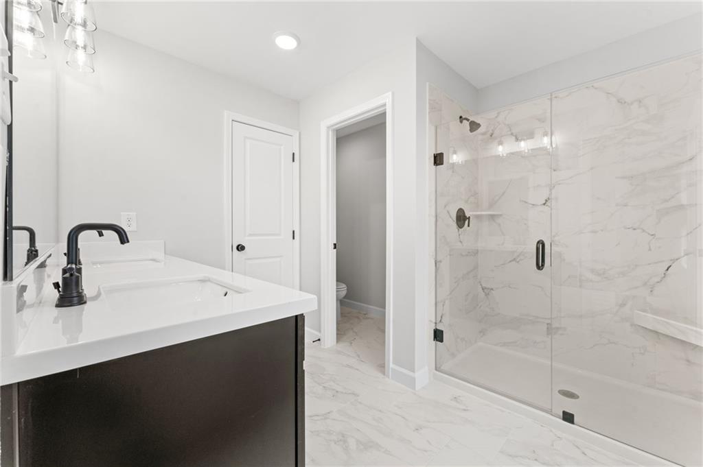 328 Colsen Drive Acworth, GA 30102 - Photo 5 of 28 a bathroom with a sink a shower and a mirror