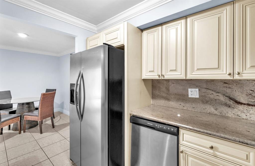 1321 Partridge Close, Unit 60 Pompano Beach, FL 33064 - Photo 12 of 28 a kitchen with stainless steel appliances granite countertop a refrigerator and a sink