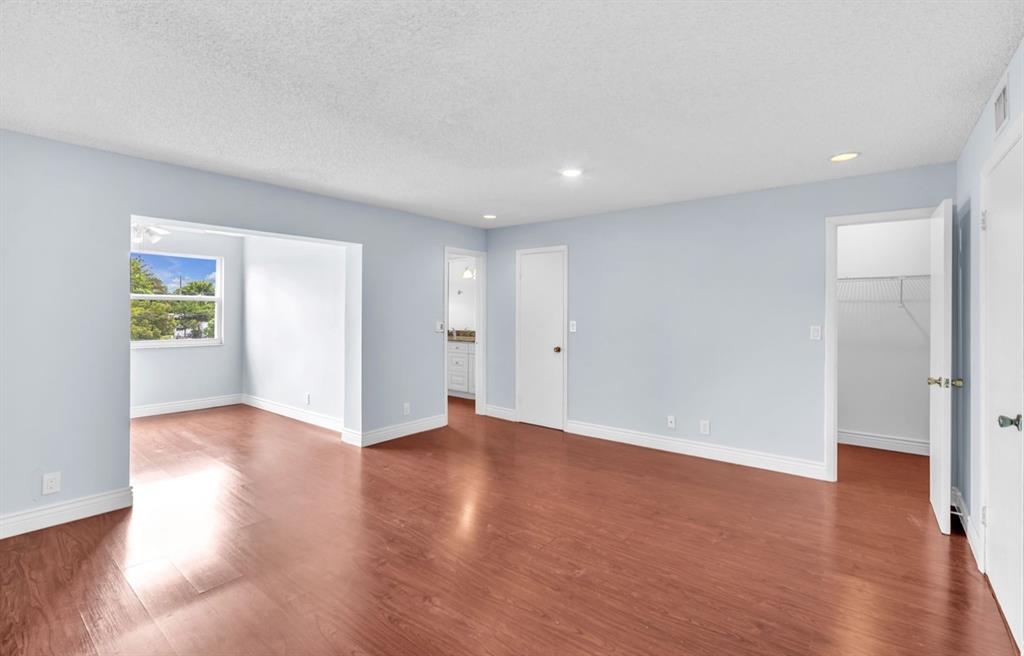 1321 Partridge Close, Unit 60 Pompano Beach, FL 33064 - Photo 17 of 28 an empty room with wooden floor & windows
