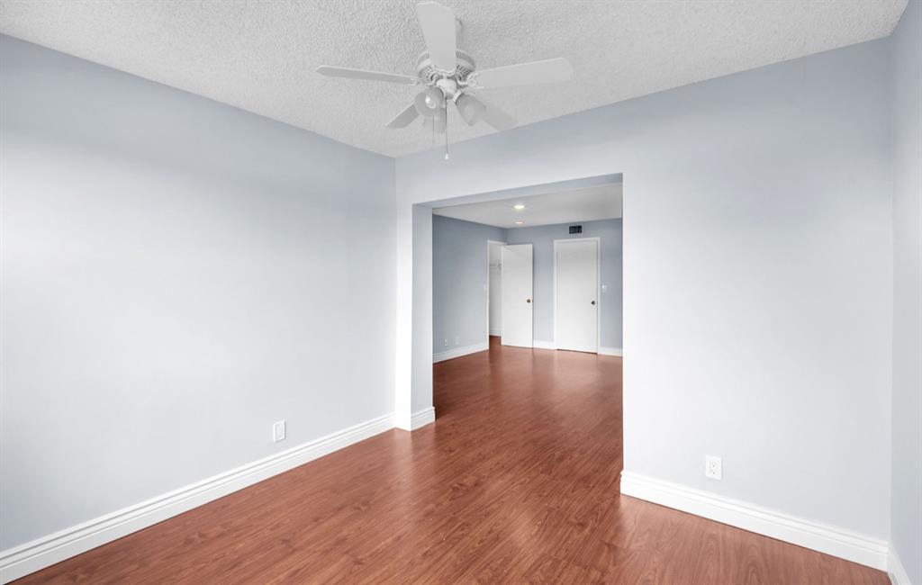 1321 Partridge Close, Unit 60 Pompano Beach, FL 33064 - Photo 20 of 28 a view of an empty room with wooden floor