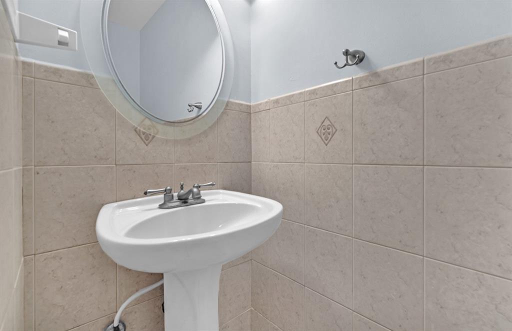 1321 Partridge Close, Unit 60 Pompano Beach, FL 33064 - Photo 26 of 28 a bathroom with a sink and a mirror