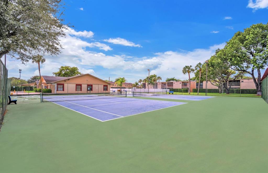 1321 Partridge Close, Unit 60 Pompano Beach, FL 33064 - Photo 28 of 28 a view of tennis ground with trees