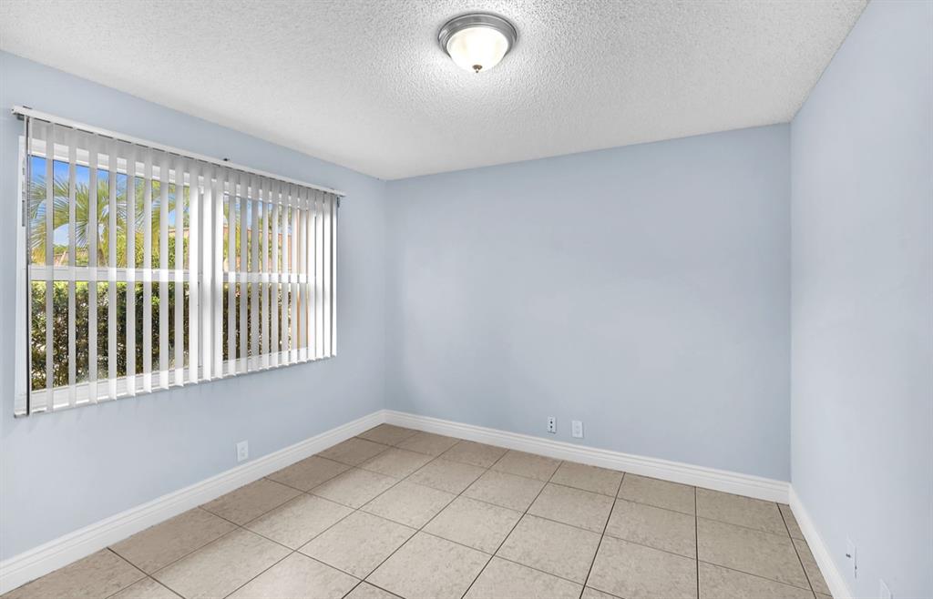 1321 Partridge Close, Unit 60 Pompano Beach, FL 33064 - Photo 5 of 28 a view of an empty room with a window
