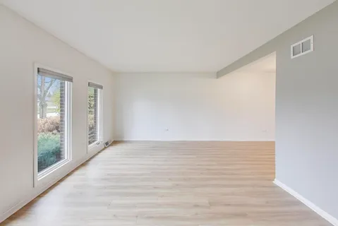a view of an empty room and wooden floor