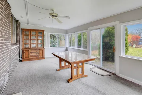 a room with pool table and windows