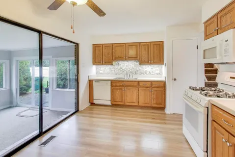 a bathroom with a granite countertop sink a mirror and a bathtub